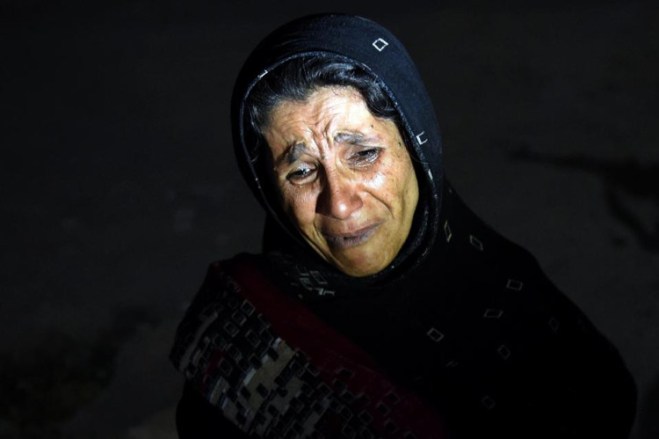 An Afghan woman cries as she looks for her son after a suicide attack at the entrance to the Police Academy in Kabul killed more than 20 cadets. (Photo: Wakil Kohsar/AFP) 